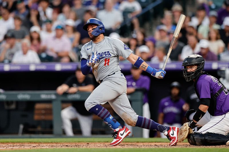 Jun 17, 2024; Denver, Colorado, USA; Los Angeles Dodgers shortstop Miguel Rojas (11) hits an RBI double in the seventh inning against the Colorado Rockies at Coors Field. Mandatory Credit: Isaiah J. Downing-USA TODAY Sports