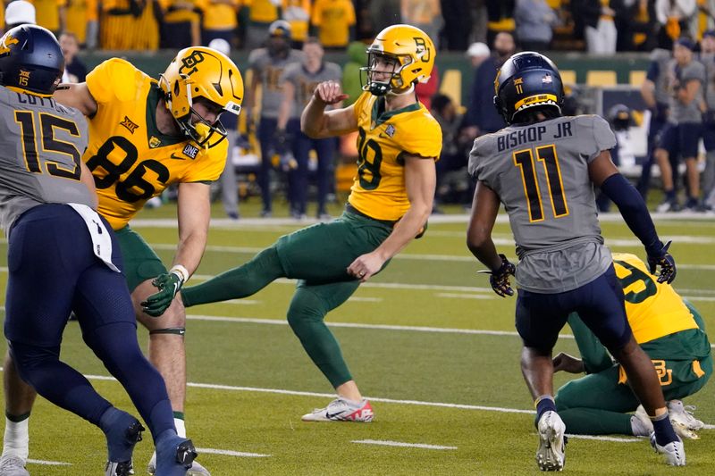 Nov 25, 2023; Waco, Texas, USA; Baylor Bears place kicker Isaiah Hankins (98) follows thru on 39-yard field goal during the second half against the West Virginia Mountaineers at McLane Stadium. Mandatory Credit: Raymond Carlin III-USA TODAY Sports