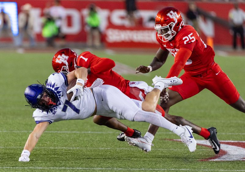 Sep 16, 2023; Houston, Texas, USA; TCU Horned Frogs wide receiver JP Richardson (7) is tackled by Houston Cougars defensive back Alex Hogan (1) to turn the ball over on downs in the first half at TDECU Stadium. Mandatory Credit: Thomas Shea-USA TODAY Sports