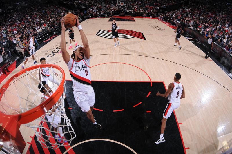 PORTLAND, OR - MARCH 22:  Moses Brown #10 of the Portland Trail Blazers grabs the rebound during the game on March 22, 2024 at the Moda Center Arena in Portland, Oregon. NOTE TO USER: User expressly acknowledges and agrees that, by downloading and or using this photograph, user is consenting to the terms and conditions of the Getty Images License Agreement. Mandatory Copyright Notice: Copyright 2024 NBAE (Photo by Cameron Browne/NBAE via Getty Images)