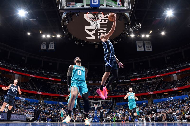 ORLANDO, FL - MARCH 19: Jalen Suggs #4 of the Orlando Magic drives to the basket during the game against the Charlotte Hornets on March 19, 2024 at the Kia Center in Orlando, Florida. NOTE TO USER: User expressly acknowledges and agrees that, by downloading and or using this photograph, User is consenting to the terms and conditions of the Getty Images License Agreement. Mandatory Copyright Notice: Copyright 2024 NBAE (Photo by Fernando Medina/NBAE via Getty Images)