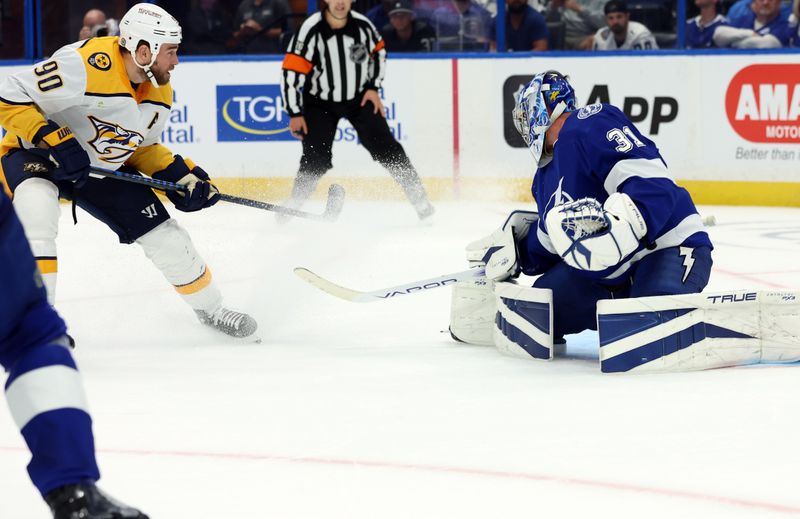 Oct 10, 2023; Tampa, Florida, USA; Nashville Predators center Ryan O'Reilly (90) scores on Tampa Bay Lightning goaltender Jonas Johansson (31) during the second period at Amalie Arena. Mandatory Credit: Kim Klement Neitzel-USA TODAY Sports