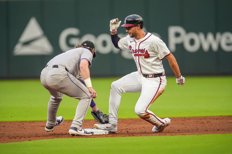 Sep 4, 2024; Cumberland, Georgia, USA; Atlanta Braves first baseman Matt Olson (28) is safe ahead of the tag by Colorado Rockies second baseman after hitting a double during the first inning at Truist Park. Mandatory Credit: Dale Zanine-Imagn Images