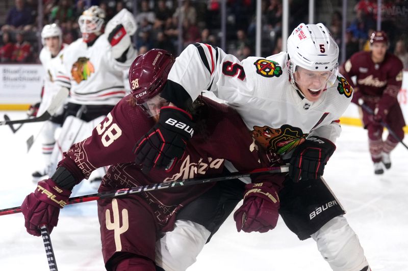 Mar 18, 2023; Tempe, Arizona, USA; Arizona Coyotes center Liam O'Brien (38) and Chicago Blackhawks defenseman Connor Murphy (5) battle for position during the second period at Mullett Arena. Mandatory Credit: Joe Camporeale-USA TODAY Sports