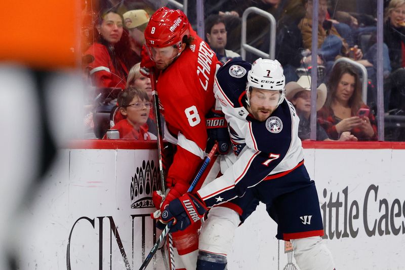 Nov 11, 2023; Detroit, Michigan, USA;  Columbus Blue Jackets center Sean Kuraly (7) checks Detroit Red Wings defenseman Ben Chiarot (8) in the third period at Little Caesars Arena. Mandatory Credit: Rick Osentoski-USA TODAY Sports