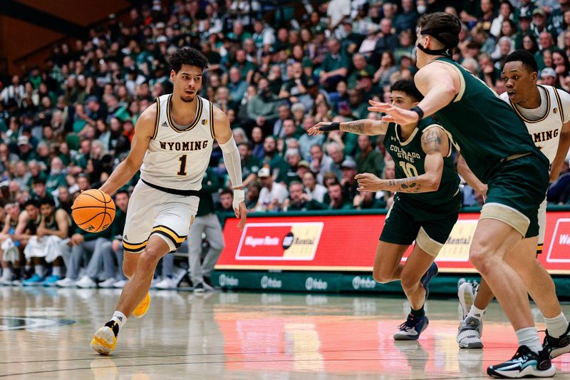 Mar 2, 2024; Fort Collins, Colorado, USA; Wyoming Cowboys guard Brendan Wenzel (1) controls the ball against Colorado State Rams guard Nique Clifford (10) and forward Patrick Cartier (12) in the second half at Moby Arena. Mandatory Credit: Isaiah J. Downing-USA TODAY Sports