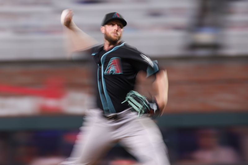 Jun 4, 2025; Atlanta, Georgia, USA; Arizona Diamondbacks starting pitcher Merrill Kelly (29) throws against the Atlanta Braves in the sixth inning at Truist Park. Mandatory Credit: Brett Davis-Imagn Images