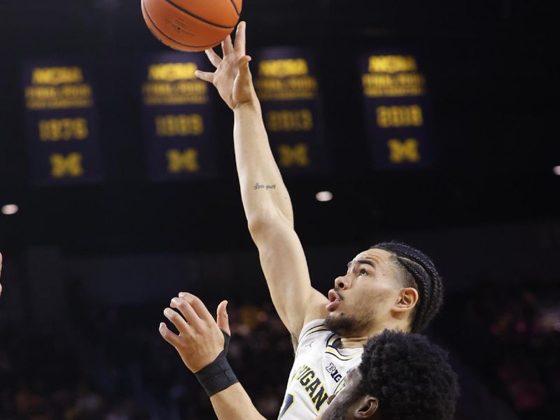 Feb 3, 2024; Ann Arbor, Michigan, USA;  Michigan Wolverines forward Olivier Nkamhoua (13) shoots on Rutgers Scarlet Knights center Emmanuel Ogbole (22) in the first half at Crisler Center. Mandatory Credit: Rick Osentoski-USA TODAY Sports