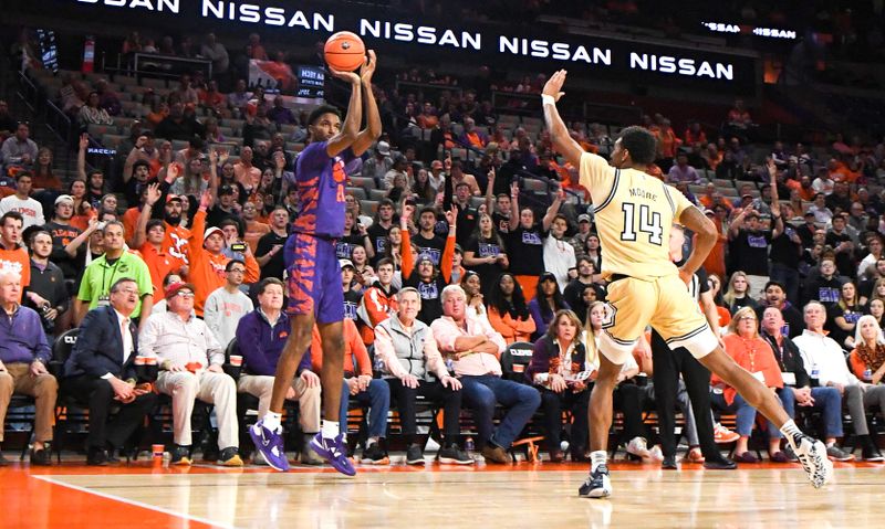 Jan 24, 2023; Clemson, South Carolina, USA; Clemson freshman forward Chauncey Wiggins (21) makes a three-point shot near Georgia Tech forward Jason Moore (14) during the second half at Littlejohn Coliseum. Mandatory Credit: Ken Ruinard-USA TODAY Sports