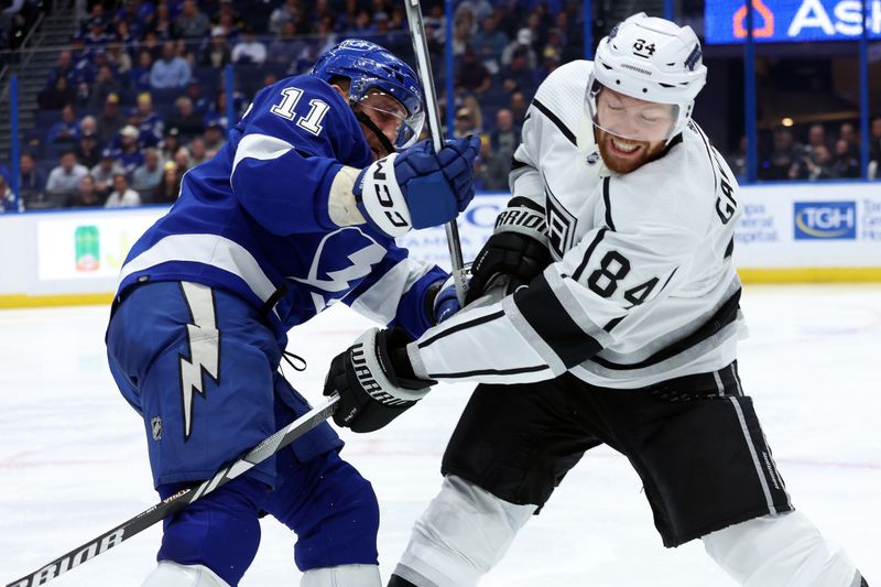 Jan 9, 2024; Tampa, Florida, USA; Tampa Bay Lightning center Luke Glendening (11) defends Los Angeles Kings defenseman Vladislav Gavrikov (84) during the third period at Amalie Arena. Mandatory Credit: Kim Klement Neitzel-USA TODAY Sports