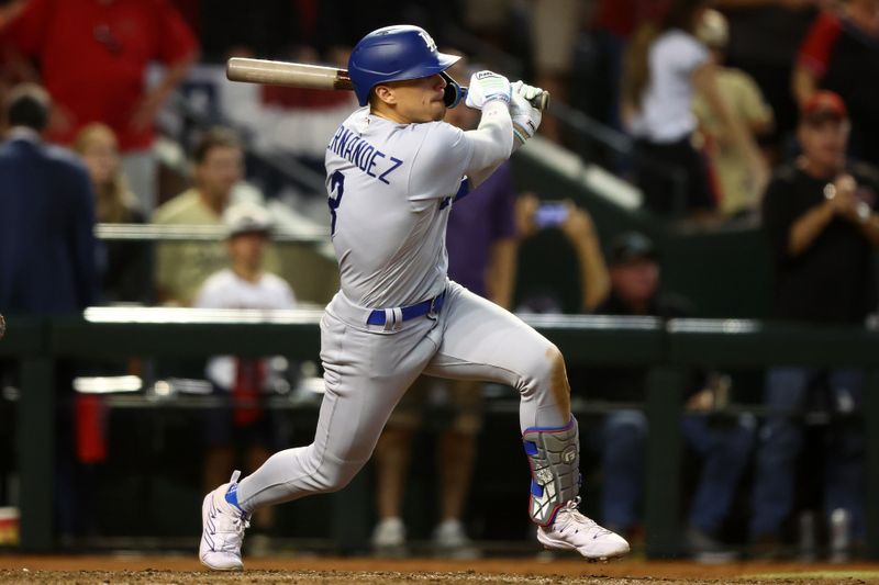 Oct 11, 2023; Phoenix, Arizona, USA; Los Angeles Dodgers shortstop Enrique Hernandez (8) hits a RBI single against the Arizona Diamondbacks in the seventh inning for game three of the NLDS for the 2023 MLB playoffs at Chase Field. Mandatory Credit: Mark J. Rebilas-USA TODAY Sports