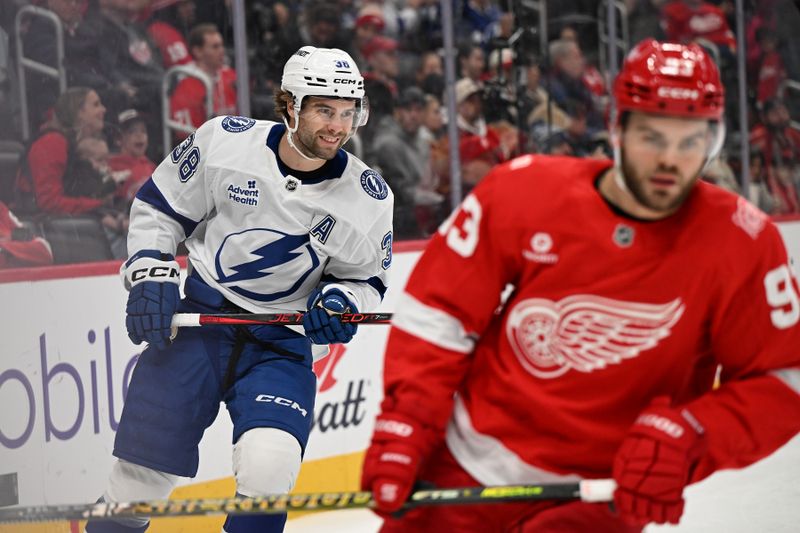 Nov 28, 2025; Detroit, Michigan, USA; Tampa Bay Lightning left wing Brandon Hagel (38) smiles after scoring an empty net goal against the Detroit Red Wings in the third period at Little Caesars Arena. Mandatory Credit: Lon Horwedel-Imagn Images
