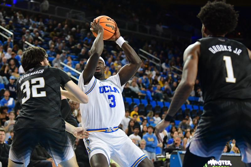 January 14, 2024; Los Angeles, California, USA; UCLA Bruins forward Adem Bona (3) moves to the basket against Washington Huskies forward Wilhelm Breidenbach (32) during the second half at Pauley Pavilion. Mandatory Credit: Gary A. Vasquez-USA TODAY Sports