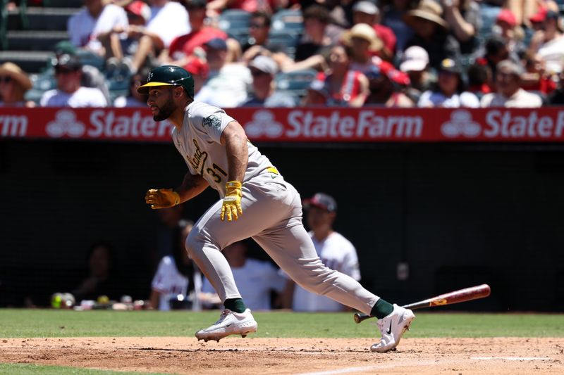 Jul 28, 2024; Anaheim, California, USA;  Oakland Athletics second baseman Abraham Toro (31) hits an RBI single during the third inning against the Los Angeles Angels at Angel Stadium. Mandatory Credit: Kiyoshi Mio-USA TODAY Sports