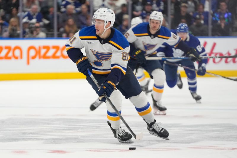 Oct 24, 2024; Toronto, Ontario, CAN; St. Louis Blues forward Dylan Holloway (81) carries the puck against the Toronto Maple Leafs during the second period at Scotiabank Arena. Mandatory Credit: John E. Sokolowski-Imagn Images