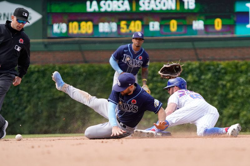 May 29, 2023; Chicago, Illinois, USA; Chicago Cubs third baseman Miles Mastrobuoni (20) steals second base as Tampa Bay Rays second baseman Brandon Lowe (8) loses his glove during the eighth inning at Wrigley Field. Mandatory Credit: David Banks-USA TODAY Sports