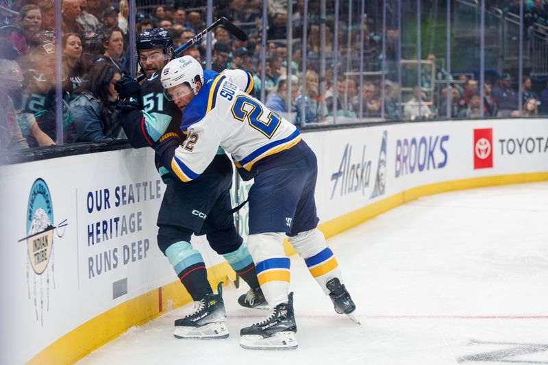 Oct 8, 2024; Seattle, Washington, USA; St. Louis Blues defenseman Ryan Suter (22) holds Seattle Kraken center Shane Wright (51) against the glass during the first period at Climate Pledge Arena. Mandatory Credit: Caean Couto-Imagn Images