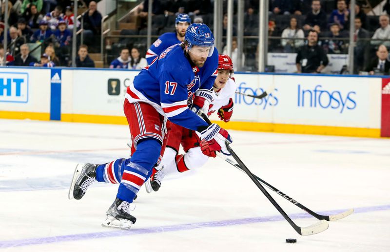 Jan 2, 2024; New York, New York, USA; New York Rangers right wing Blake Wheeler (17) skates with the puck past Carolina Hurricanes center Martin Necas (88) during the first period at Madison Square Garden. Mandatory Credit: Danny Wild-USA TODAY Sports