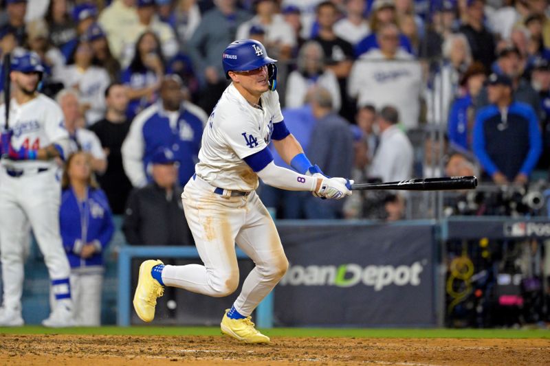 Oct 20, 2024; Los Angeles, California, USA; Los Angeles Dodgers third baseman Enrique Hernandez (8) hits an RBI single in the eighth inning against the New York Mets during game six of the NLCS for the 2024 MLB playoffs at Dodger Stadium. Mandatory Credit: Jayne Kamin-Oncea-Imagn Images