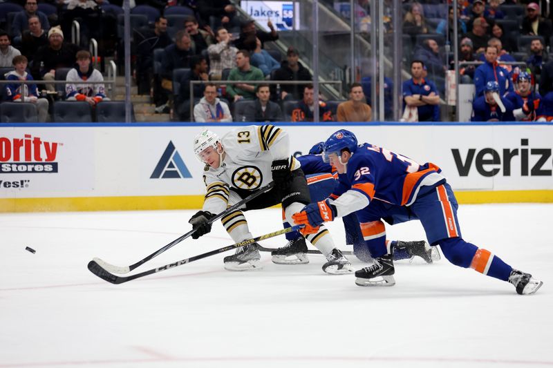 Mar 2, 2024; Elmont, New York, USA; Boston Bruins center Charlie Coyle (13) takes a shot against New York Islanders center Kyle MacLean (32) during the first period at UBS Arena. Mandatory Credit: Brad Penner-USA TODAY Sports