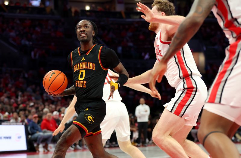 Dec 23, 2025; Columbus, Ohio, USA; Grambling State Tigers guard Derrius Ward (0) looks to pass the ball as Ohio State Buckeyes forward Brandon Noel (14) defends during the first half at Value City Arena. Mandatory Credit: Joseph Maiorana-Imagn Images