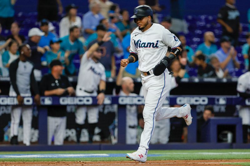 Jun 4, 2023; Miami, Florida, USA; Miami Marlins second baseman Luis Arraez (3) scores after a three-run home run by designated hitter Garrett Cooper (not pictured) against the Oakland Athletics during the fifth inning at loanDepot Park. Mandatory Credit: Sam Navarro-USA TODAY Sports