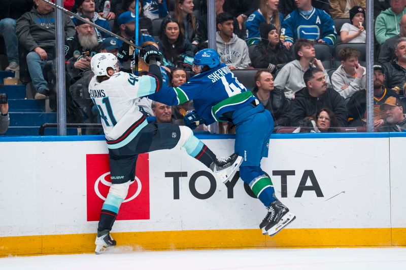 Jan 2, 2026; Vancouver, British Columbia, CAN; Vancouver Canucks forward Kiefer Sherwood (44) checks Seattle Kraken defenseman Ryker Evans (41) in the second period at Rogers Arena. Mandatory Credit: Bob Frid-Imagn Images