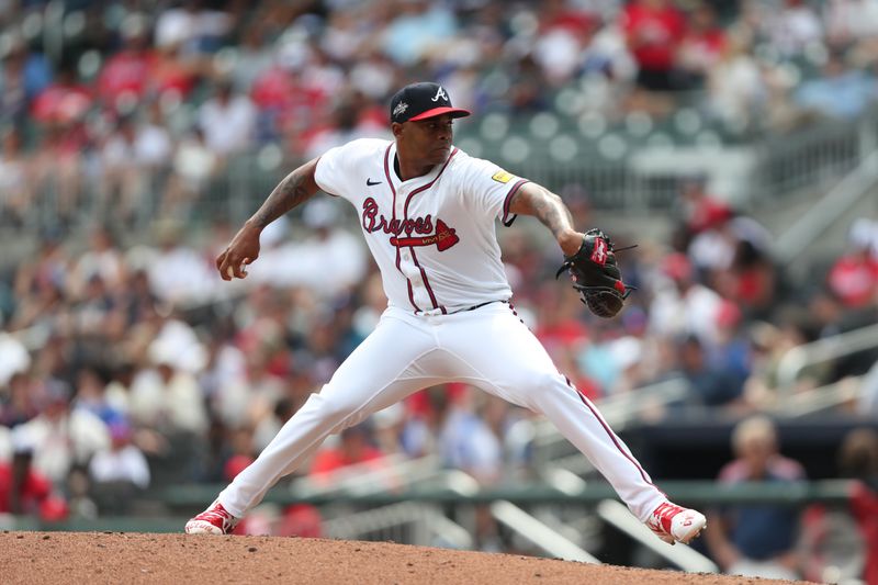 Jun 29, 2025; Cumberland, Georgia, Atlanta Braves relief pitcher Raisel Iglesias (26) pitches during a game against the Philadelphia Phillies during the ninth inning at Truist Park. Mandatory Credit: Mady Mertens-Imagn Images