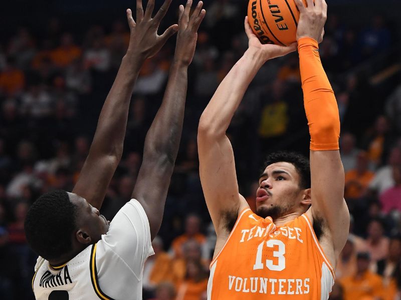 Mar 10, 2023; Nashville, TN, USA; Tennessee Volunteers forward Olivier Nkamhoua (13) shoots against Missouri Tigers forward Mohamed Diarra (0) during the second half at Bridgestone Arena. Mandatory Credit: Christopher Hanewinckel-USA TODAY Sports