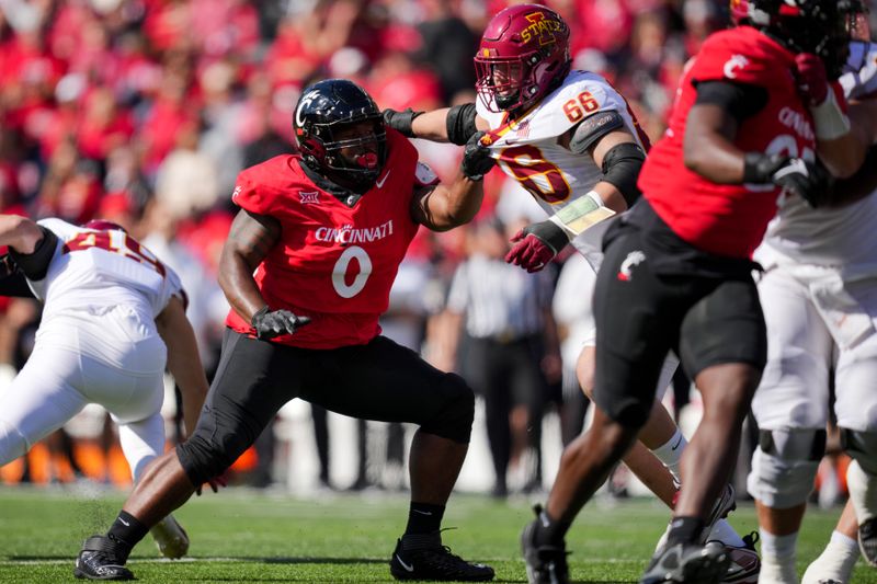 Oct 14, 2023; Cincinnati, Ohio, USA;  Cincinnati Bearcats defensive end Jowon Briggs (0) battles for position on the field against Iowa State Cyclones offensive lineman Tyler Miller (66) in the first half at Nippert Stadium. Mandatory Credit: Aaron Doster-USA TODAY Sports