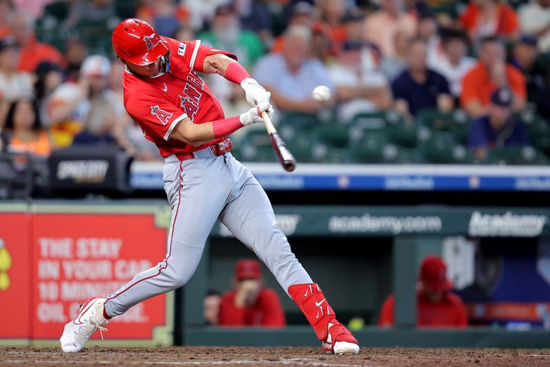 Sep 1, 2025; Houston, Texas, USA; Los Angeles Angels pinch hitter Logan O'Hoppe (14) hits a single against the Houston Astros during the eighth inning at Daikin Park. Mandatory Credit: Erik Williams-Imagn Images