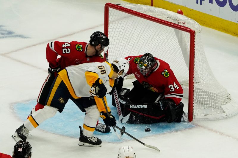 Oct 25, 2024; Chicago, Illinois, USA; Chicago Blackhawks goaltender Petr Mrazek (34) makes a save on Nashville Predators left wing Zachary L'Heureux (68) during the third period at the United Center. Mandatory Credit: David Banks-Imagn Images