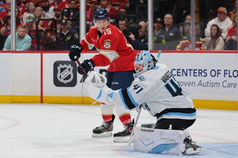 Jan 27, 2026; Sunrise, Florida, USA; Florida Panthers center Anton Lundell (15) attempts to deflect the puck against Utah Mammoth goaltender Vitek Vanecek (41) during the first period at Amerant Bank Arena. Mandatory Credit: Sam Navarro-Imagn Images