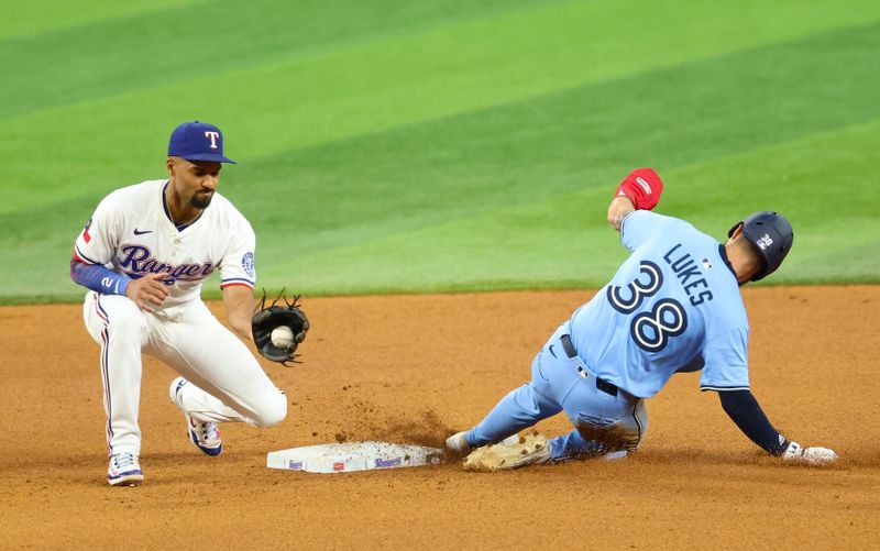 May 28, 2025; Arlington, Texas, USA; Toronto Blue Jays left fielder Nathan Lukes (38) steals second base ahead of the tag by Texas Rangers second baseman Marcus Semien (2) during the seventh inning at Globe Life Field. Mandatory Credit: Kevin Jairaj-Imagn Images