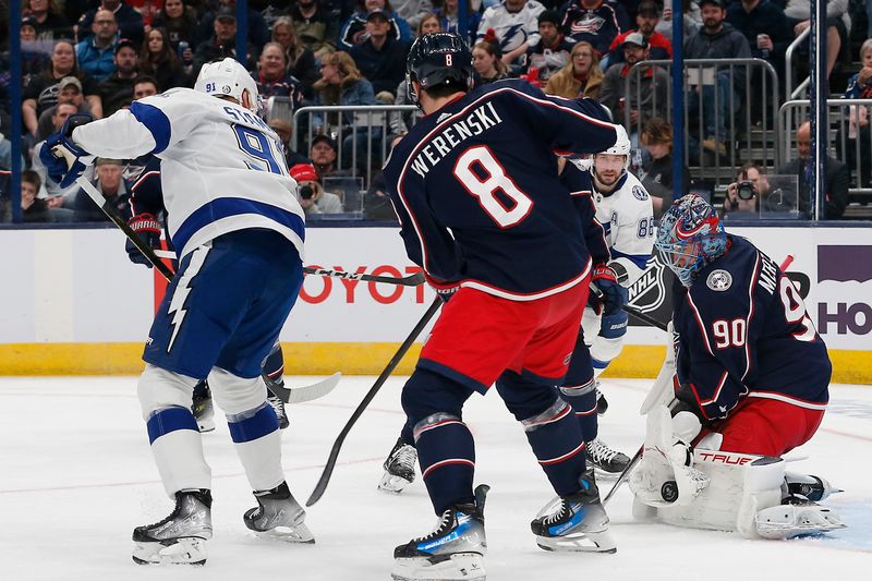 Feb 10, 2024; Columbus, Ohio, USA; Columbus Blue Jackets goalie Elvis Merzlikins (90) makes a glove save against the Tampa Bay Lightning during the first period at Nationwide Arena. Mandatory Credit: Russell LaBounty-USA TODAY Sports