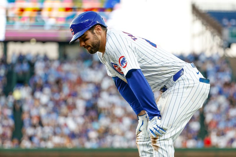 Jun 17, 2024; Chicago, Illinois, USA; Chicago Cubs outfielder Mike Tauchman (40) reacts after injuring his leg after running to first base after hitting a single against the San Francisco Giants during the third inning at Wrigley Field. Mandatory Credit: Kamil Krzaczynski-USA TODAY Sports