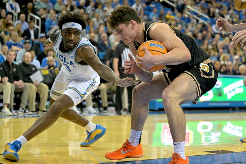 Jan 20, 2026; Los Angeles, California, USA;  UCLA Bruins guard Eric Dailey Jr. (3) and Purdue Boilermakers guard Omer Mayer (17) battle for a rebound in the first half at Pauley Pavilion presented by Wescom Financial. Mandatory Credit: Jayne Kamin-Oncea-Imagn Images