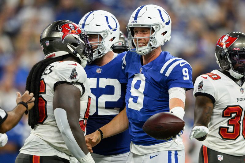 Indianapolis Colts quarterback Nick Foles (9) walks back to the huddle during an NFL football game against the Tampa Bay Buccaneers, Saturday, Aug. 27, 2022, in Indianapolis. (AP Photo/Zach Bolinger)