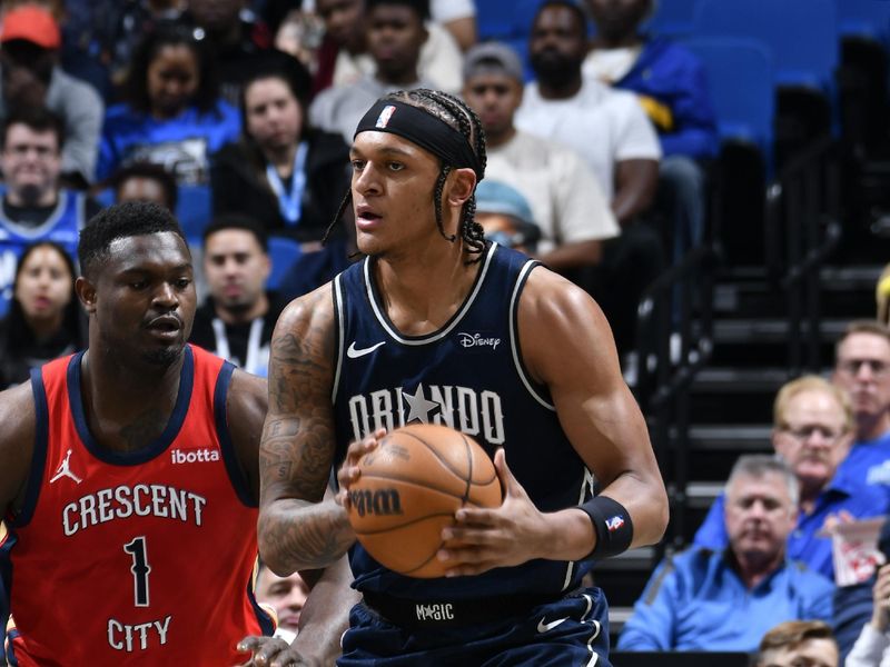 ORLANDO, FL - MARCH 21: Paolo Banchero #5 of the Orlando Magic handles the ball during the game against the New Orleans Pelicans on March 21, 2024 at Amway Center in Orlando, Florida. NOTE TO USER: User expressly acknowledges and agrees that, by downloading and or using this photograph, User is consenting to the terms and conditions of the Getty Images License Agreement. Mandatory Copyright Notice: Copyright 2024 NBAE (Photo by Fernando Medina/NBAE via Getty Images)