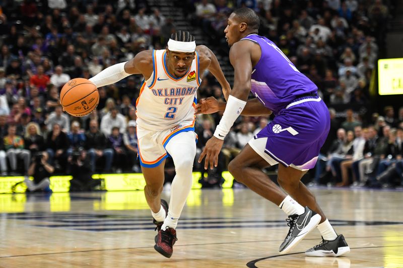 SALT LAKE CITY, UTAH - FEBRUARY 06: Shai Gilgeous-Alexander #2 of the Oklahoma City Thunder drives into Kris Dunn #11 of the Utah Jazz during the second half of a game at Delta Center on February 06, 2024 in Salt Lake City, Utah. NOTE TO USER: User expressly acknowledges and agrees that, by downloading and or using this photograph, User is consenting to the terms and conditions of the Getty Images License Agreement. (Photo by Alex Goodlett/Getty Images)