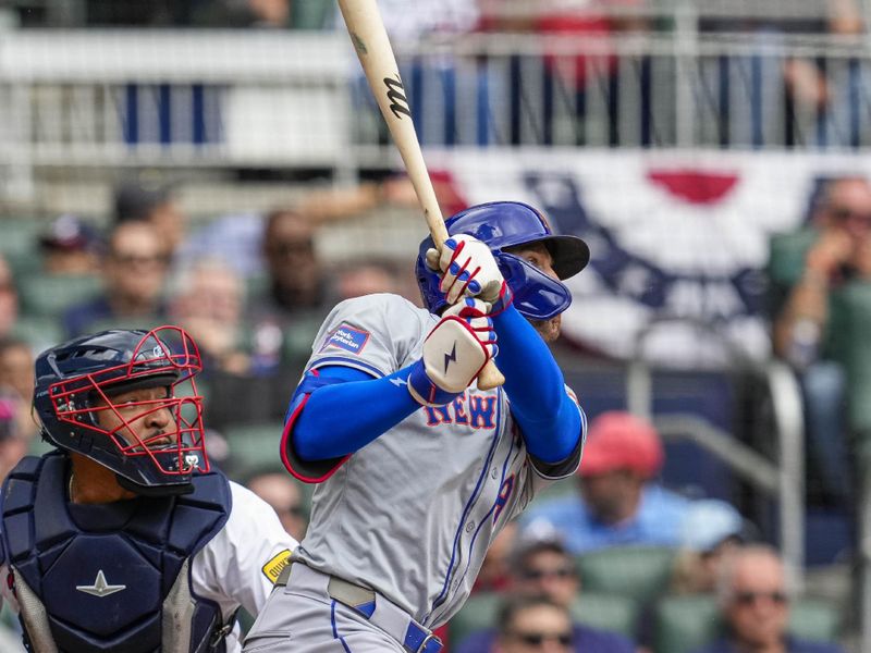 Apr 11, 2024; Cumberland, Georgia, USA; New York Mets left fielder Brandon Nimmo (9) watches his double that drives in a run against the Atlanta Braves during the second inning at Truist Park. Mandatory Credit: Dale Zanine-USA TODAY Sports