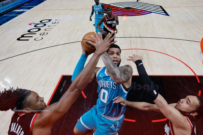 PORTLAND, OREGON - FEBRUARY 25: Miles Bridges #0 of the Charlotte Hornets goes up for a shot against Jabari Walker #34 and Dalano Banton #5 (R) of the Portland Trail Blazers during the first half at Moda Center on February 25, 2024 in Portland, Oregon. NOTE TO USER: User expressly acknowledges and agrees that, by downloading and or using this photograph, User is consenting to the terms and conditions of the Getty Images License Agreement. (Photo by Soobum Im/Getty Images)