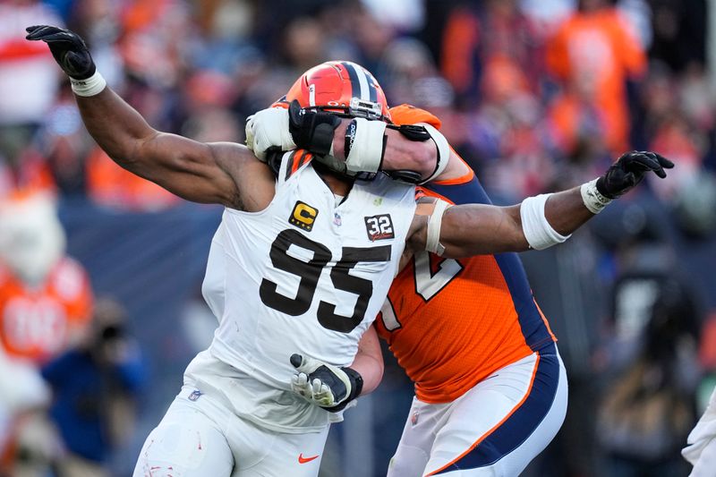 Cleveland Browns defensive end Myles Garrett (95) rushes the passer as Denver Broncos offensive tackle Garett Bolles (72) defends during the first half of an NFL football game on Sunday, Nov. 26, 2023, in Denver. (AP Photo/Jack Dempsey)