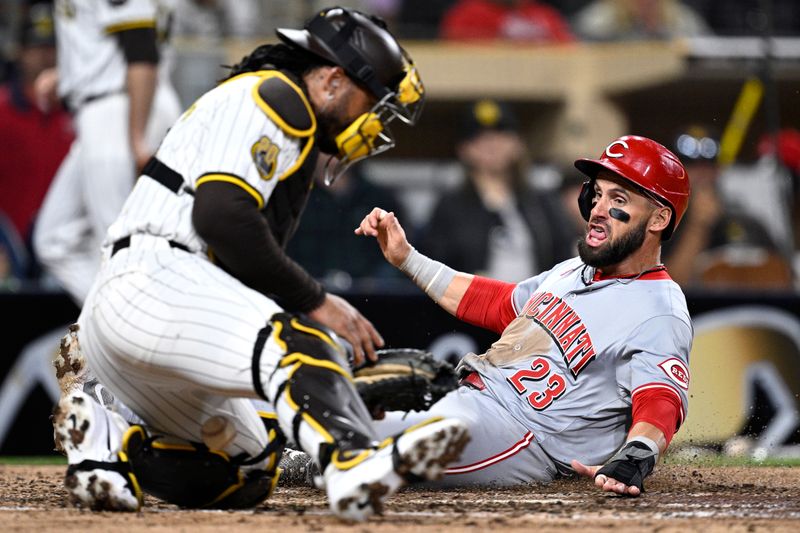 Apr 29, 2024; San Diego, California, USA; Cincinnati Reds designated hitter Nick Martini (23) scores a run ahead of the throw to San Diego Padres catcher Luis Campusano (12) during the ninth inning at Petco Park. Mandatory Credit: Orlando Ramirez-USA TODAY Sports