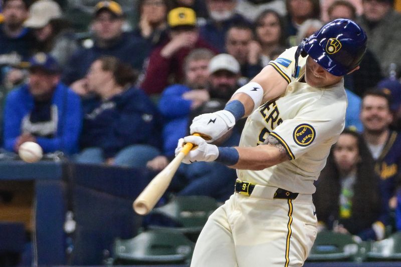 Apr 7, 2024; Milwaukee, Wisconsin, USA; Milwaukee Brewers first baseman Jake Bauers (9) hits a single to drive in a run in the first inning against the Seattle Mariners at American Family Field. Mandatory Credit: Benny Sieu-USA TODAY Sports