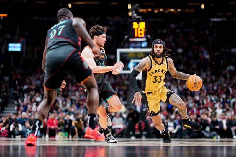 TORONTO, ON - APRIL 7: Gary Trent Jr. #33 of the Toronto Raptors dribbles against Corey Kispert #24 and Eugene Omoruyi #97 of the Washington Wizards during the first half of their basketball game at the Scotiabank Arena on April 7, 2024 in Toronto, Ontario, Canada. NOTE TO USER: User expressly acknowledges and agrees that, by downloading and/or using this Photograph, user is consenting to the terms and conditions of the Getty Images License Agreement. (Photo by Mark Blinch/Getty Images)