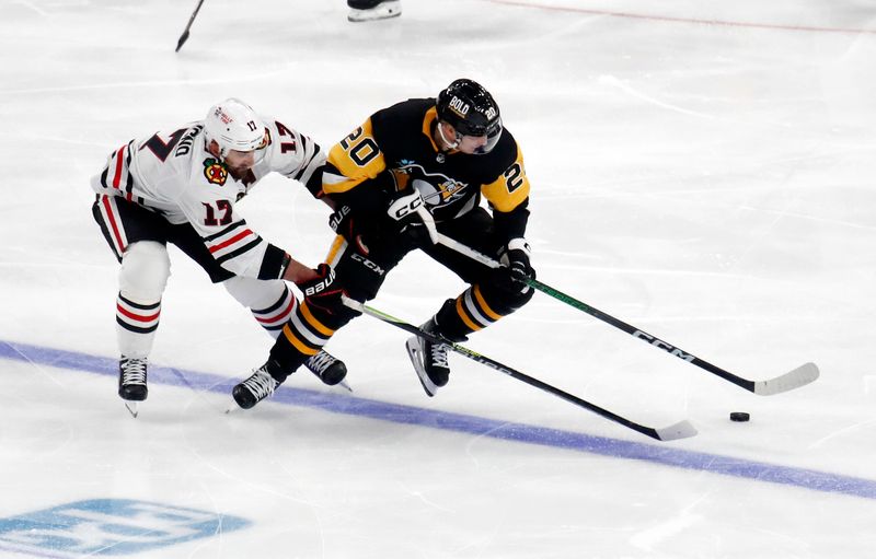 Oct 10, 2023; Pittsburgh, Pennsylvania, USA; Chicago Blackhawks left wing Nick Foligno (17) and Pittsburgh Penguins center Lars Eller (20) chase the puck during the third period at the PPG Paints Arena. Chicago won 4-2. Mandatory Credit: Charles LeClaire-USA TODAY Sports