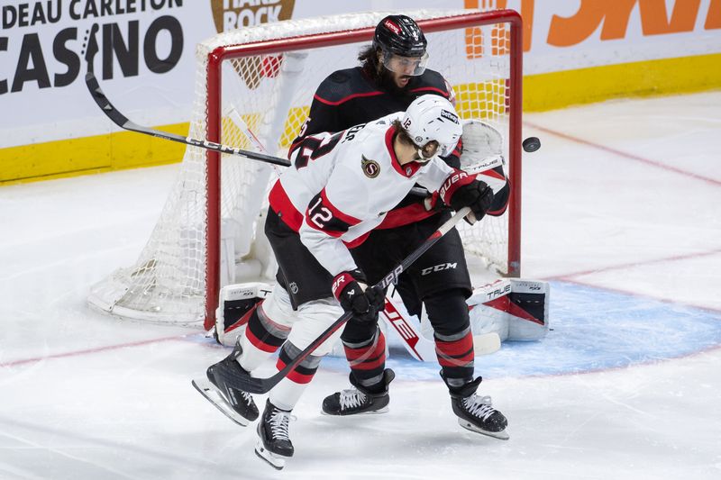 Mar 17, 2024; Ottawa, Ontario, CAN; Carolina Hurricanes defenseman Jalen Chaffield (5) blocks a shot in front of Ottawa Senators center Mark kastelic (12) in the third period at the Canadian Tire Centre. Mandatory Credit: Marc DesRosiers-USA TODAY Sports