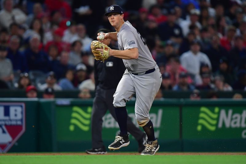 May 28, 2024; Anaheim, California, USA; New York Yankees third baseman DJ LeMahieu (26) throws to first for the out against Los Angeles Angels left fielder Taylor Ward (3) during the sixth inning at Angel Stadium. Mandatory Credit: Gary A. Vasquez-USA TODAY Sports