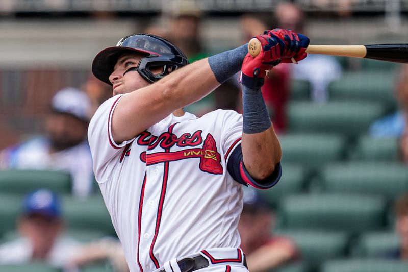 Aug 2, 2023; Cumberland, Georgia, USA; Atlanta Braves third baseman Austin Riley (27) follows through while hitting a two run home run against the Los Angeles Angels during the fourth inning at Truist Park. Mandatory Credit: Dale Zanine-USA TODAY Sports